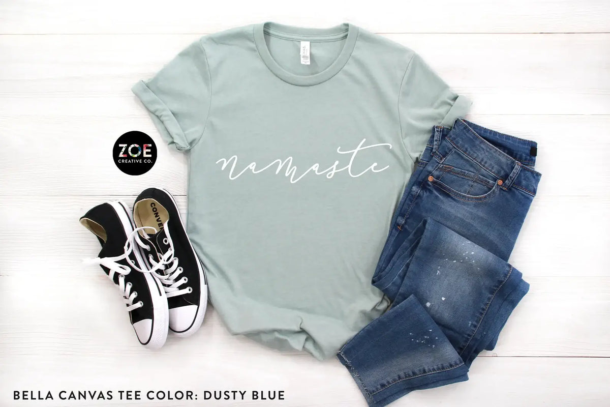 Namaste graphic tee in Dusty Blue, styled flat lay