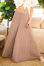 Mocha pleated palazzo pants paired with a white tie-front top