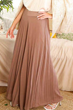 Mocha pleated palazzo pants showing the high waistband and flowing wide legs