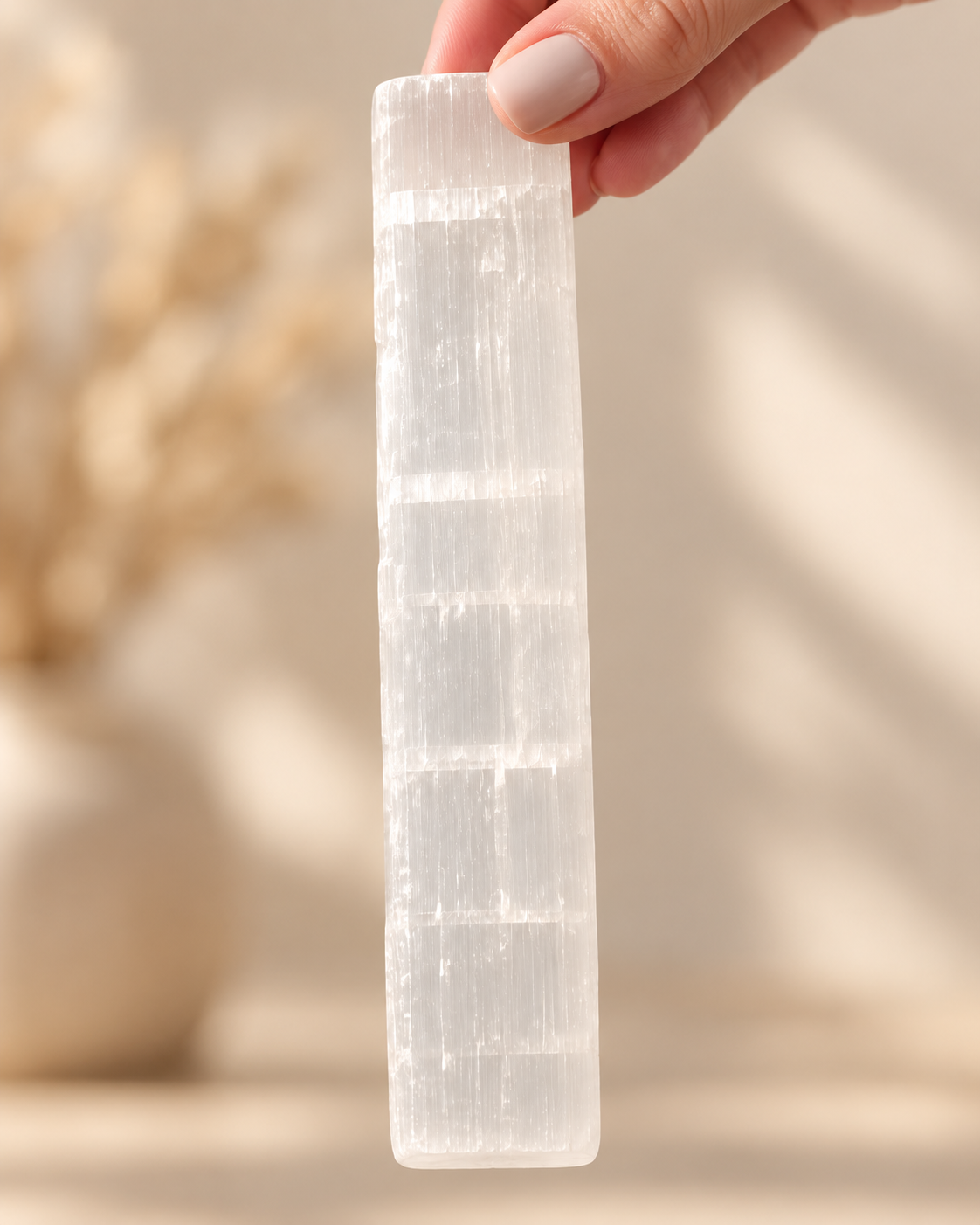 Celeste translucent crystal stick held for scale
