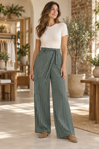 Model wearing Darcy green and ivory striped wide-leg pants