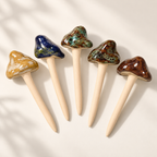 Five glossy plant mushroom decor picks in tan, blue, moss, burnt moss, and brown