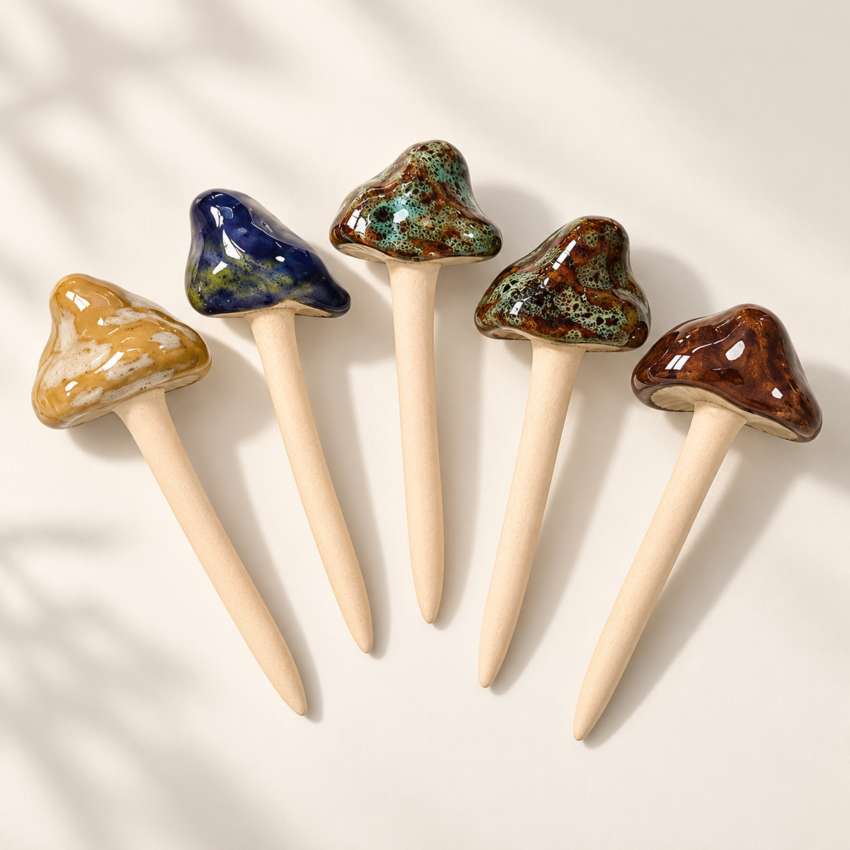 Five glossy plant mushroom decor picks in tan, blue, moss, burnt moss, and brown