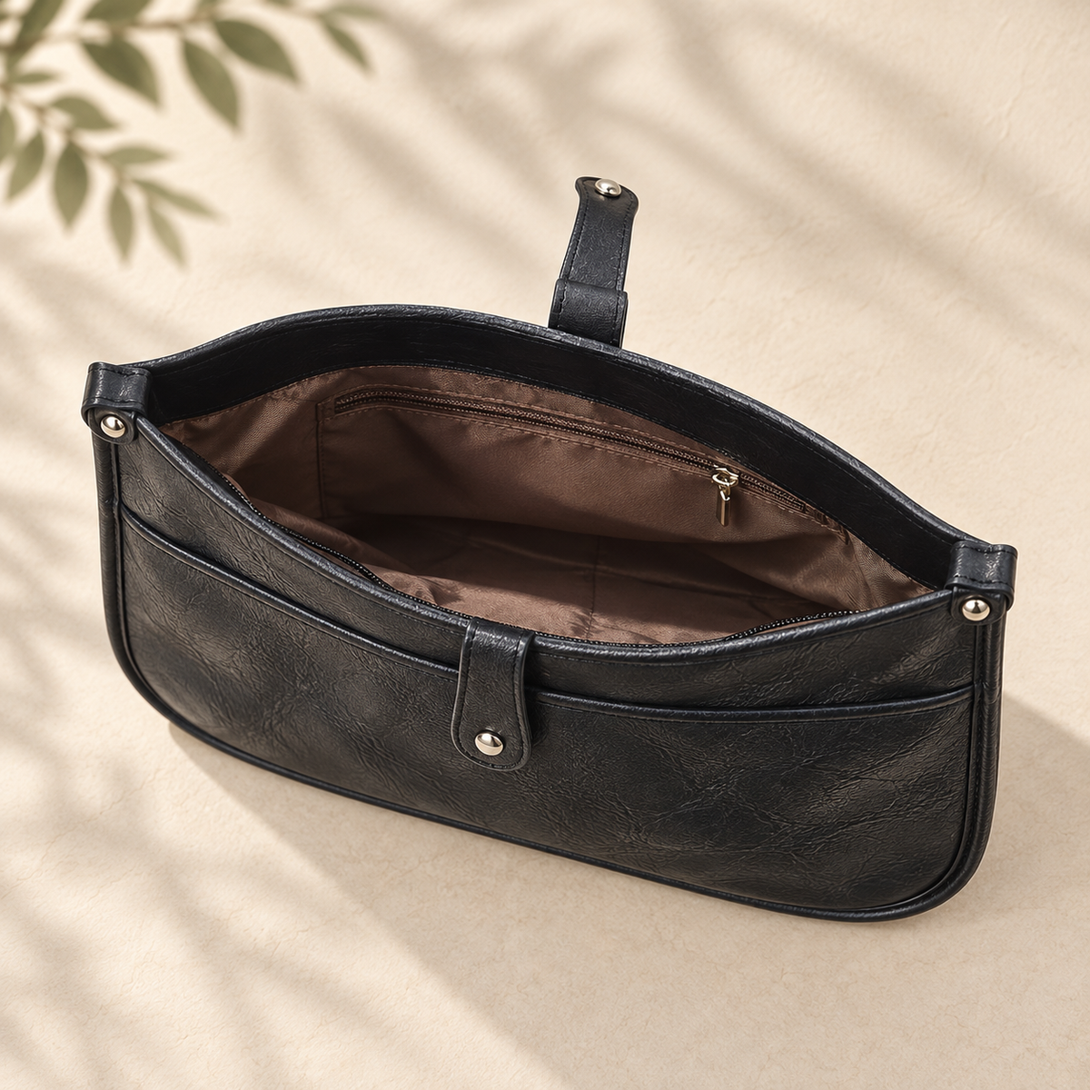 Black Sadie crossbody bag showing the brown lined zip interior