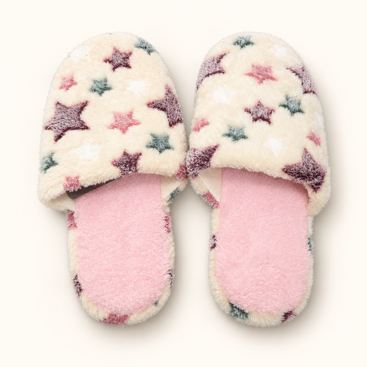 Star ivory plush slippers with pink footbeds and multicolor star print